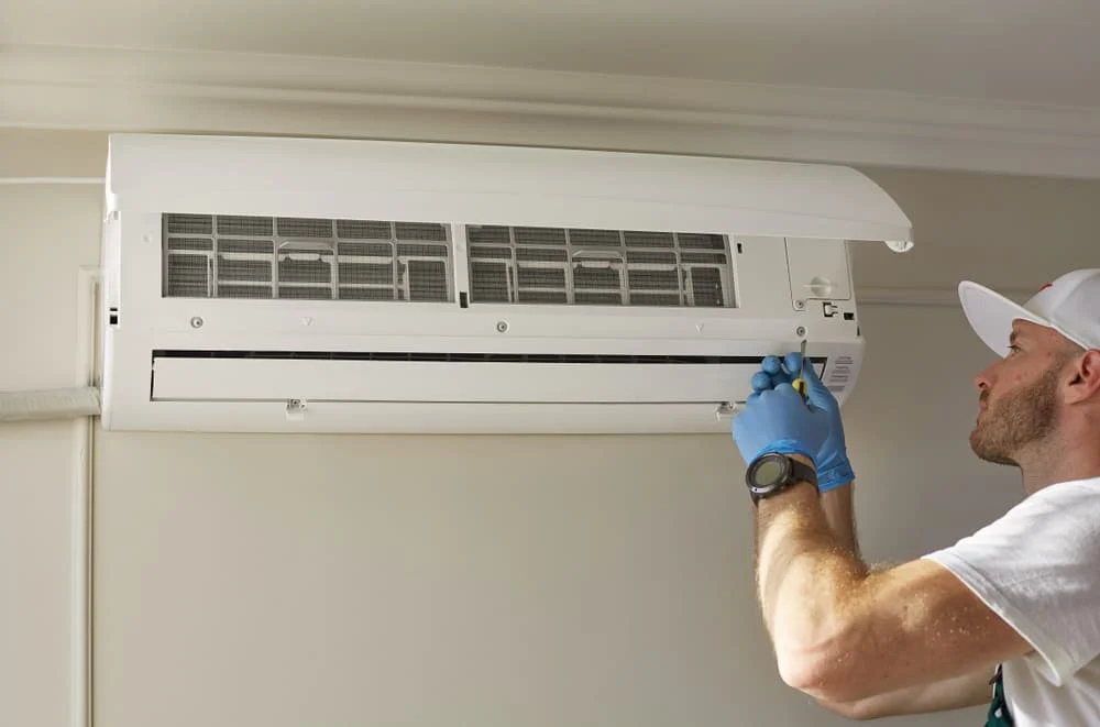 man repairing air conditioner